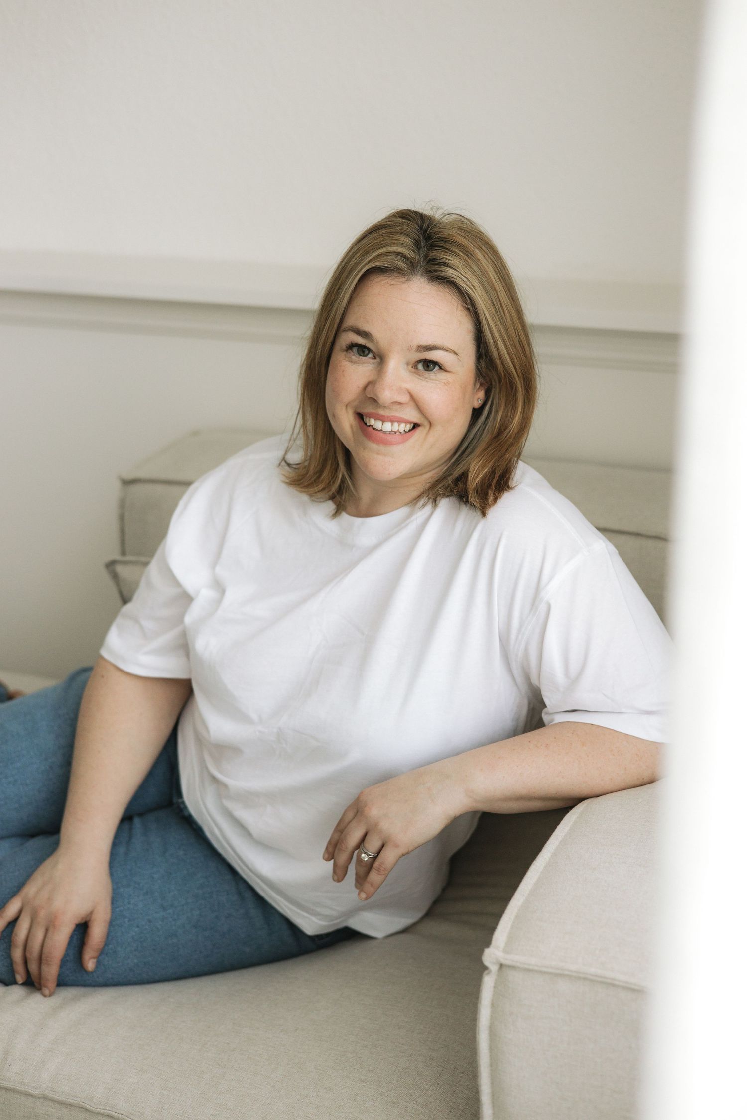 Faye McRae, Ayrshire newborn and family photographer, smiles into the camera