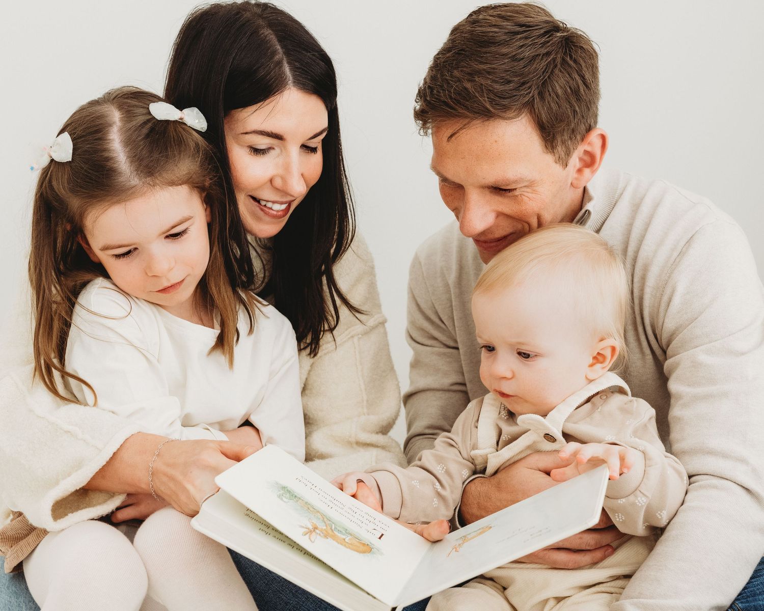 a beautiful natural moment captured of this family reading a story together, their individual personalities clear to see
