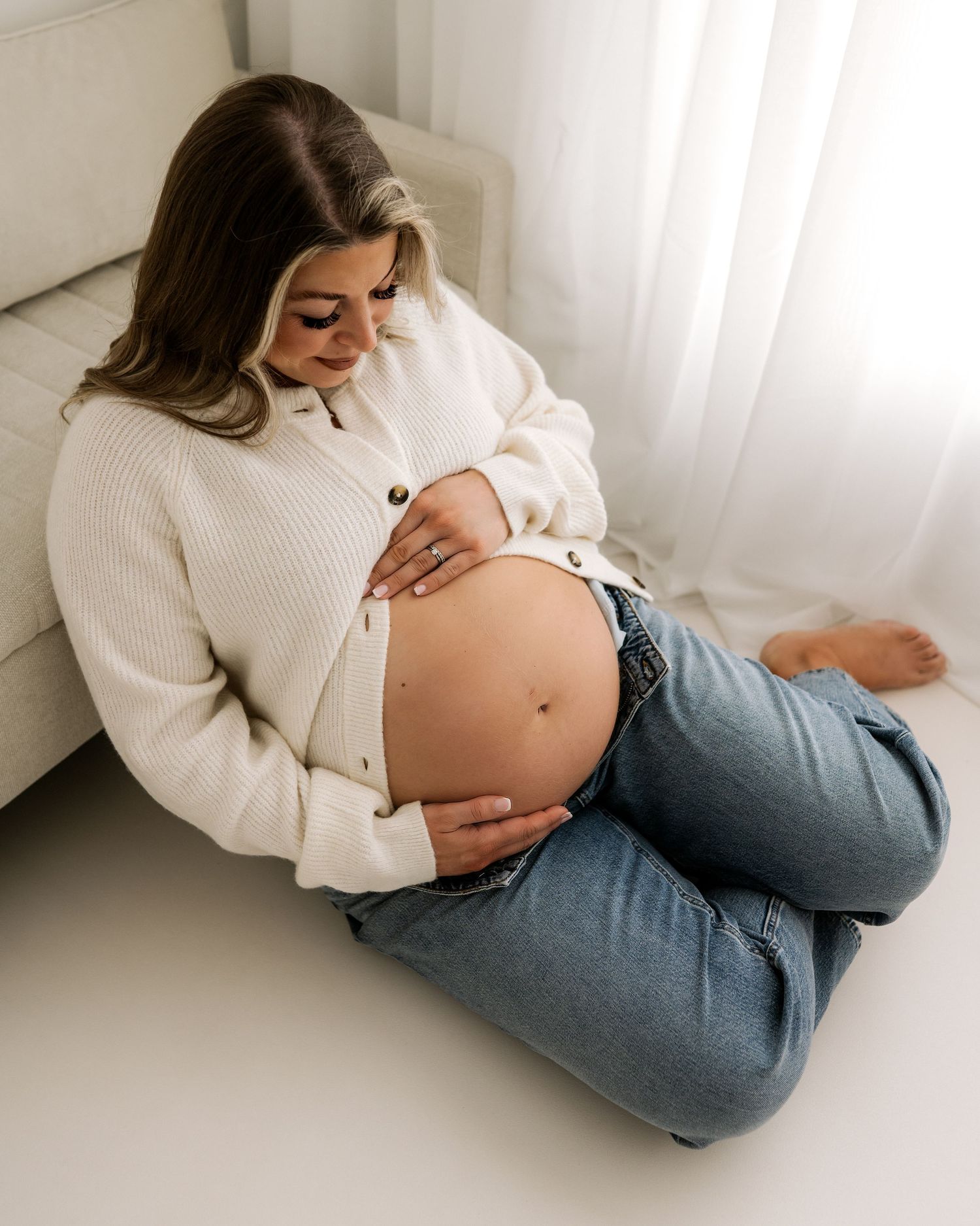 a quiet moment for this new first time mum as she cradles her bump, full of love in Faye McRae's Ayrshire studio
