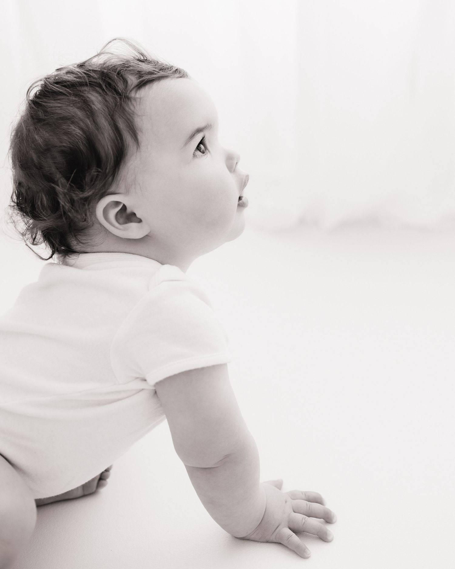 Black and white side profile of curious 1 year old captured during a timeless photography session in Ayrshire
