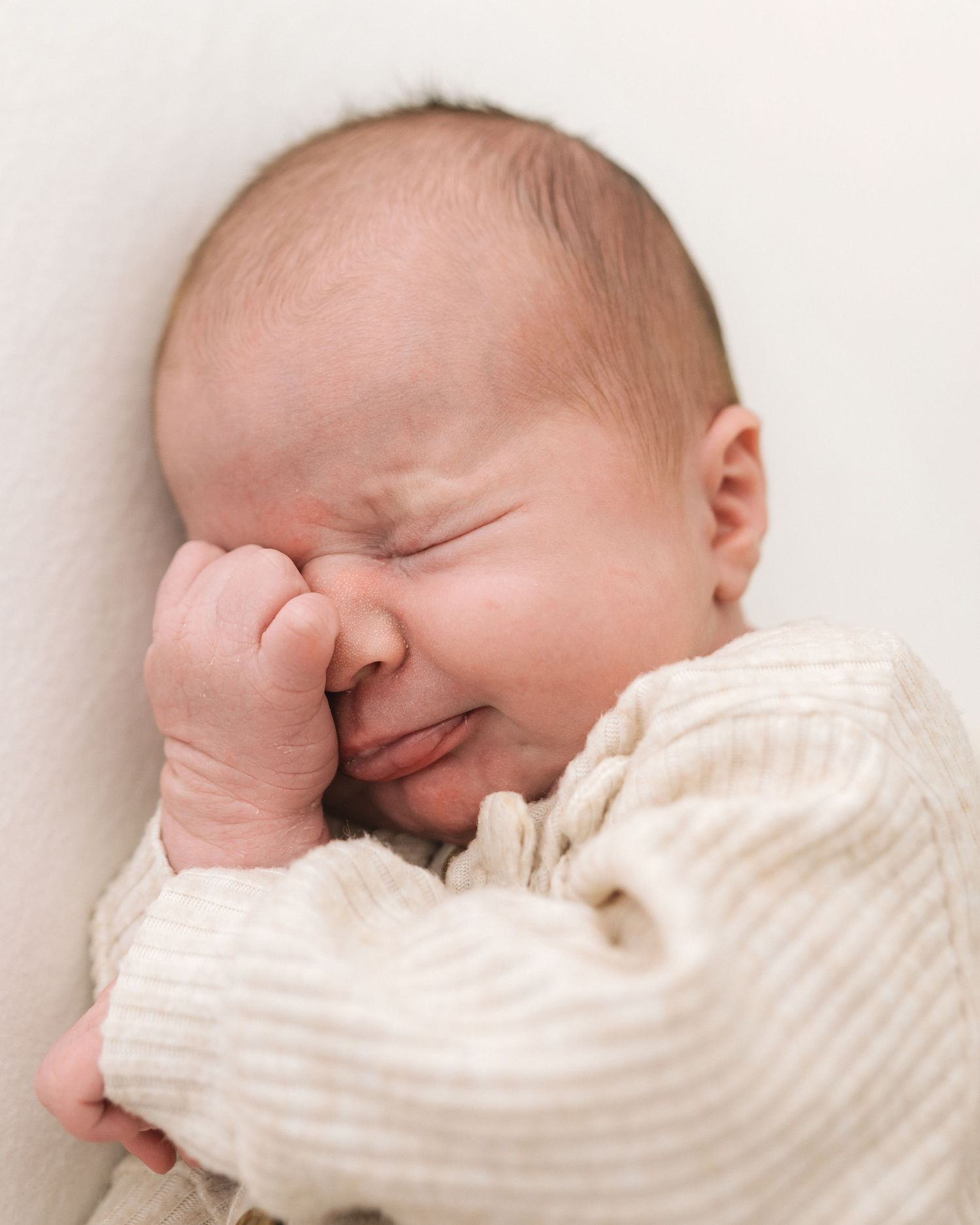 newborn baby naturally stirs during sleep in her natural newborn session in Ayr capturing tiny details of your new baby before they change