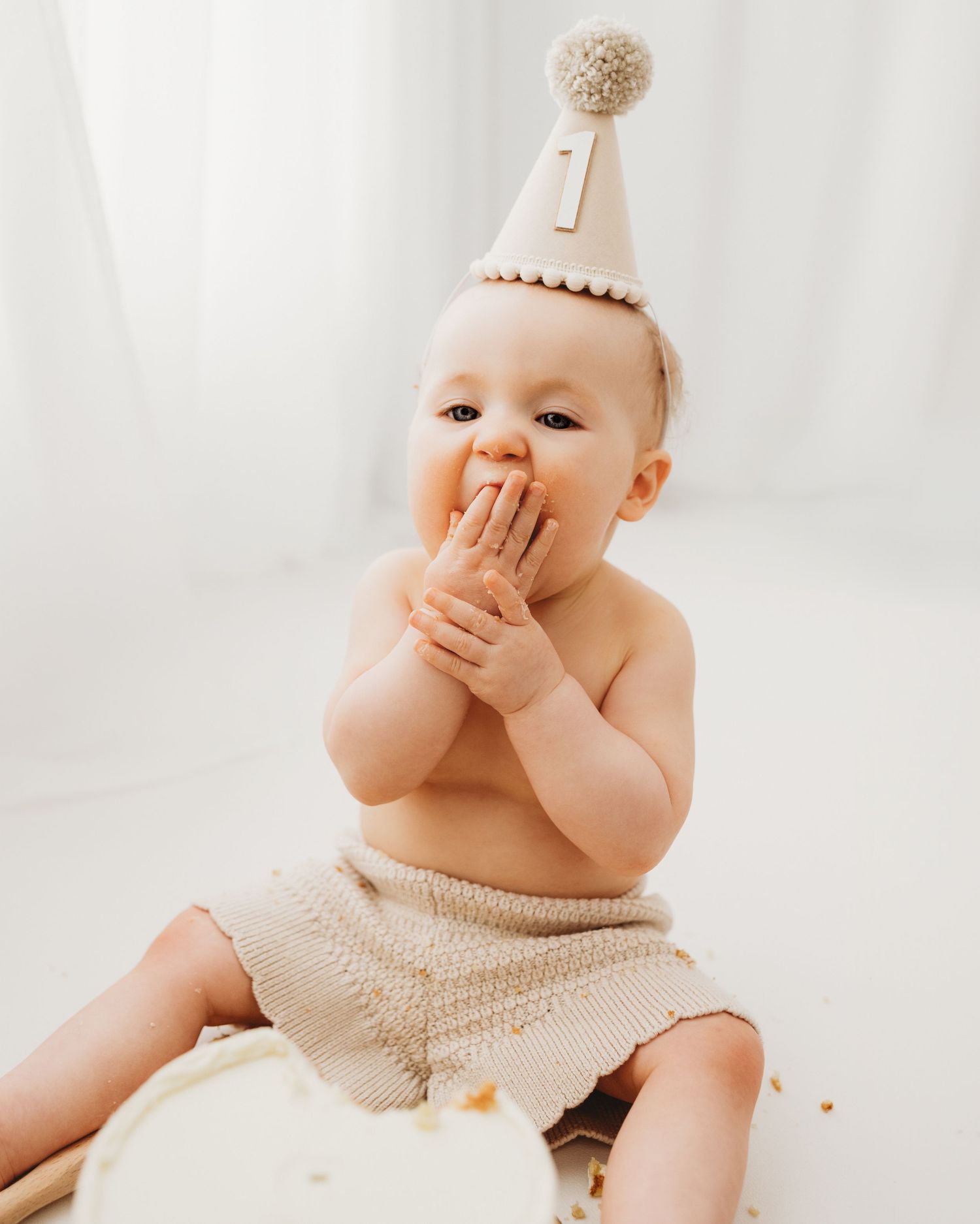 simple cake smash photo from 1st birthday photoshoot in Ayrshire's simple all-white studio that captures timeless photos of your baby