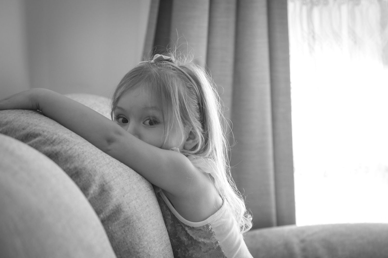 Soft, intimate morning light streaming through curtains in a quiet room.