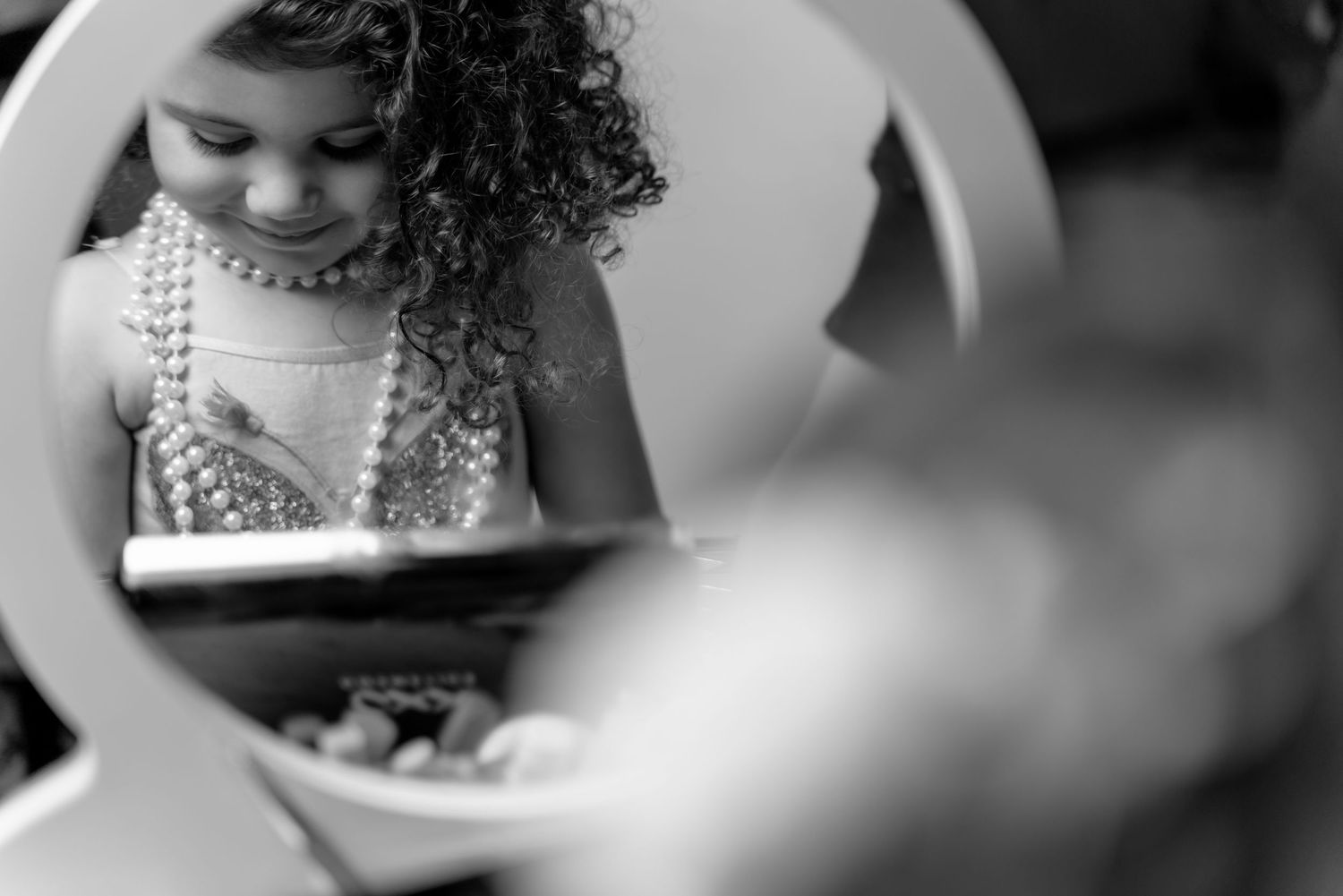 Black and white portrait series of a young child with curly hair.