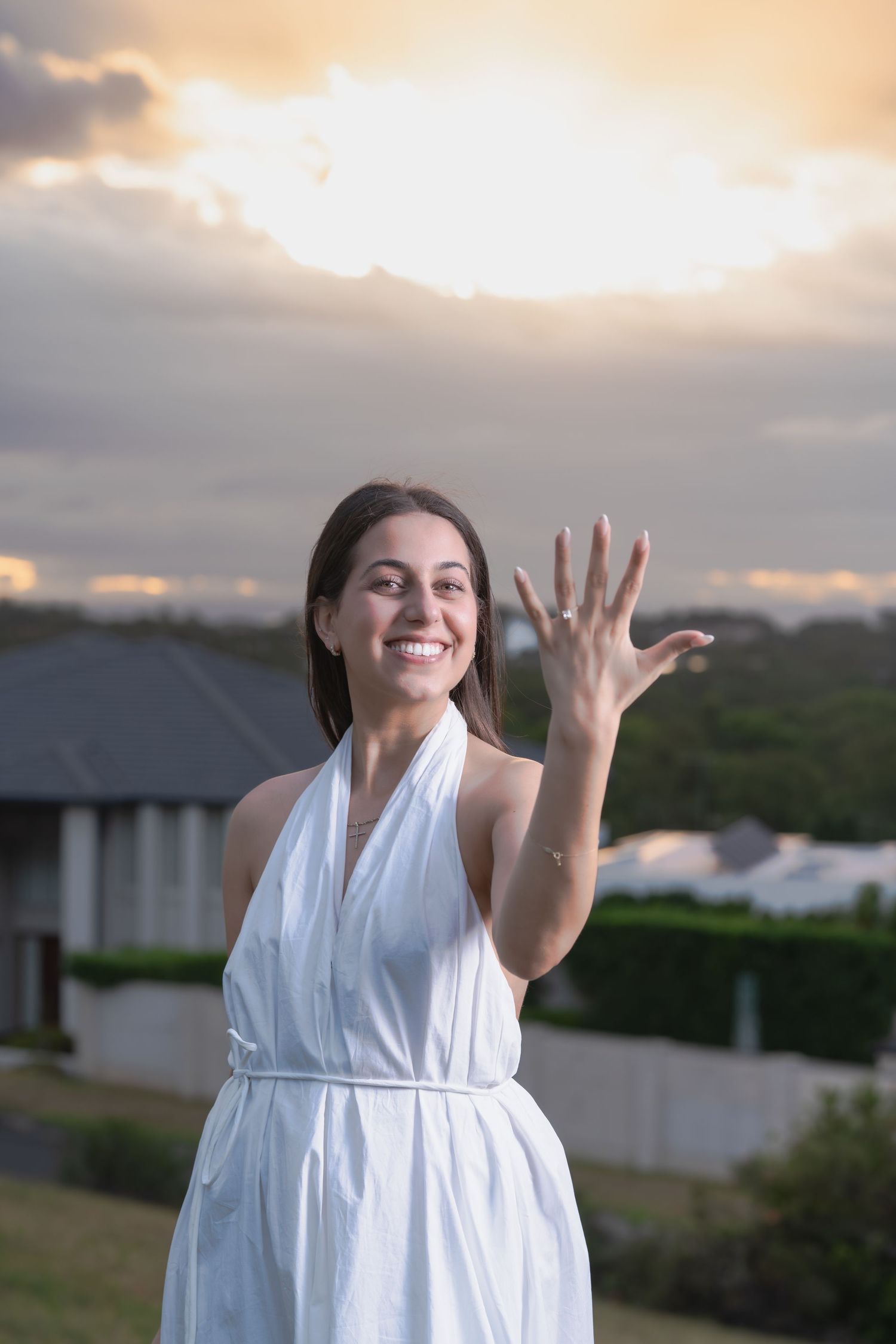 A person in a white dress twirls joyfully against a sunset sky in a series of connected action shots.