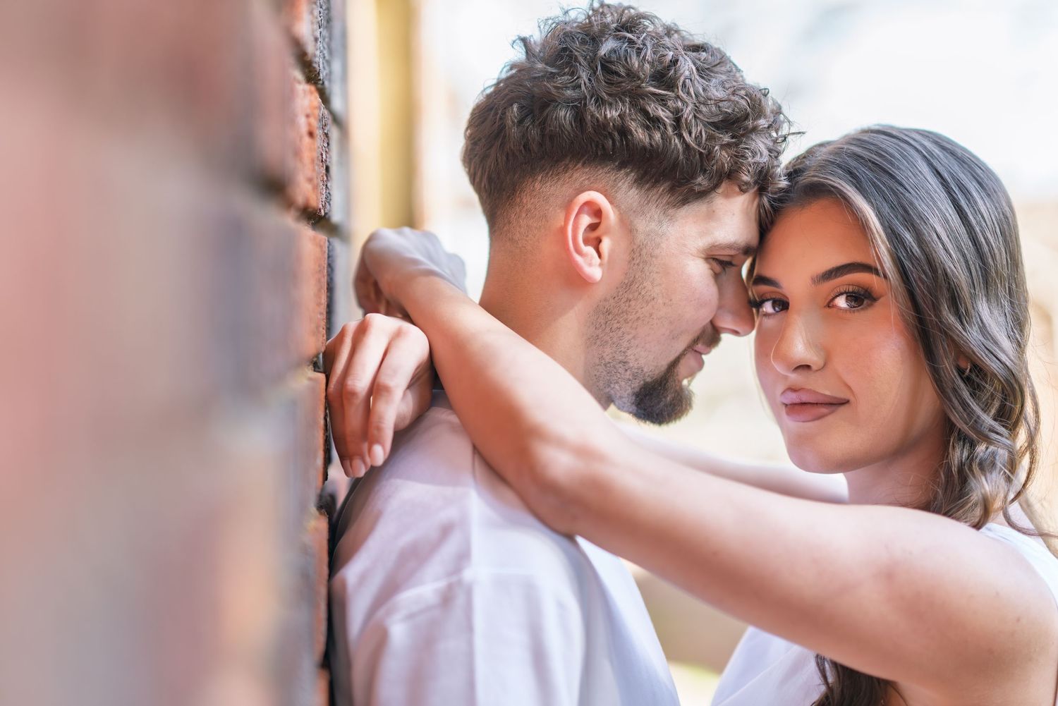 A romantic couple shares intimate moments in a series of tender poses during a professional photoshoot.