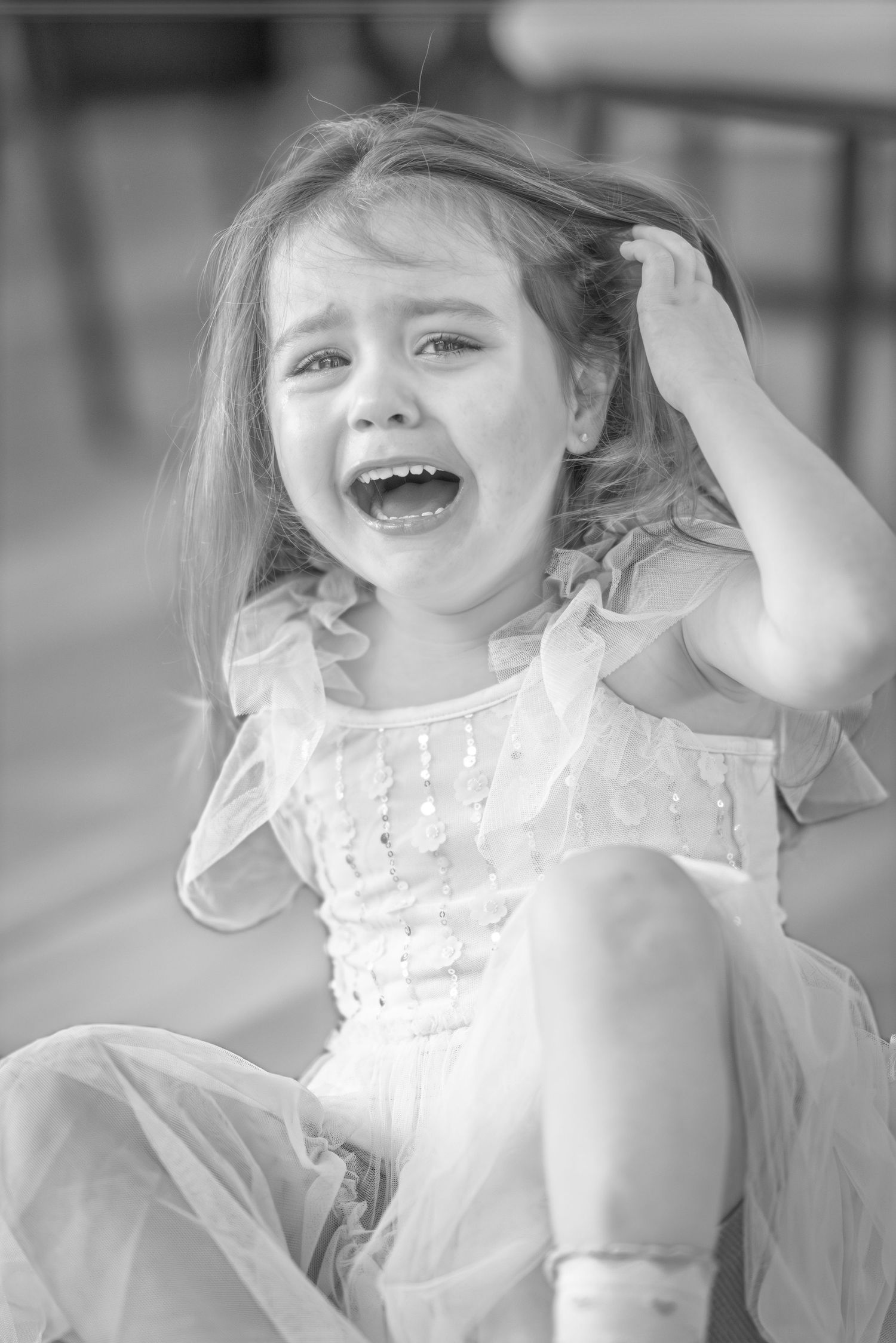 A series of black and white photos showing joyful expressions and laughter in a candid sequence.