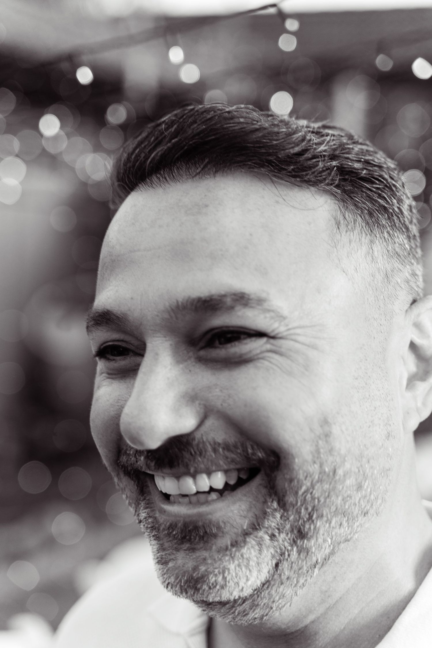 Black and white close-up portrait series showing genuine laughter and joy.