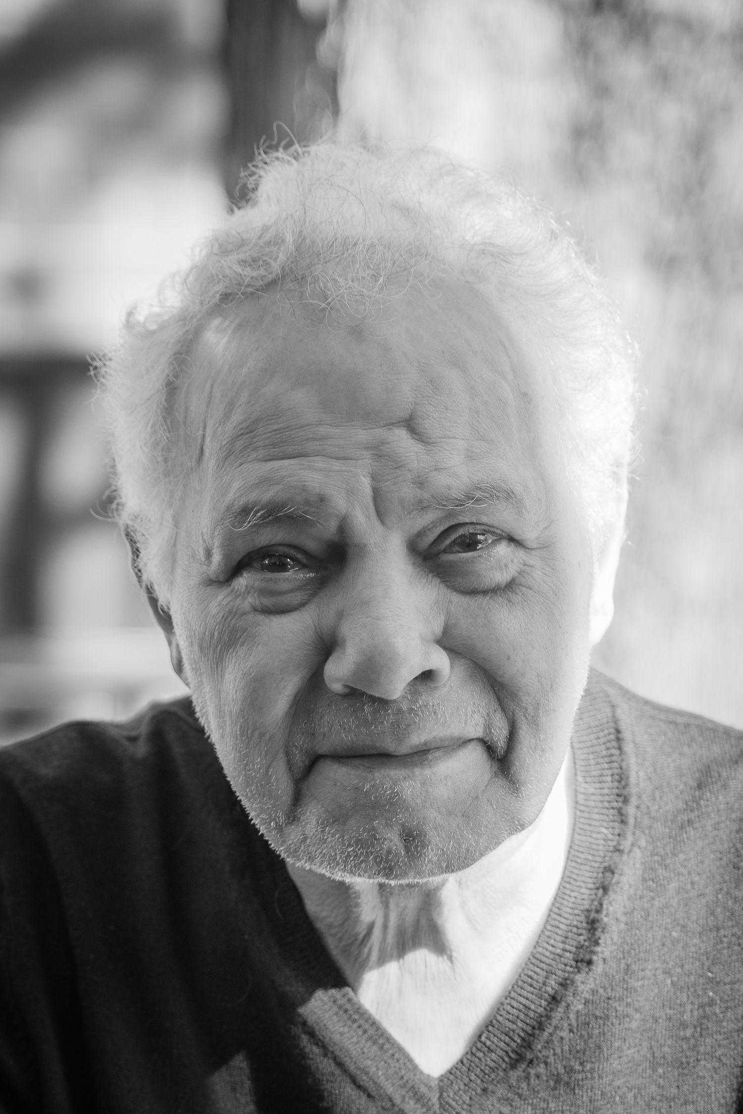 Series of black and white portraits showing joyful elderly expressions and smiles.