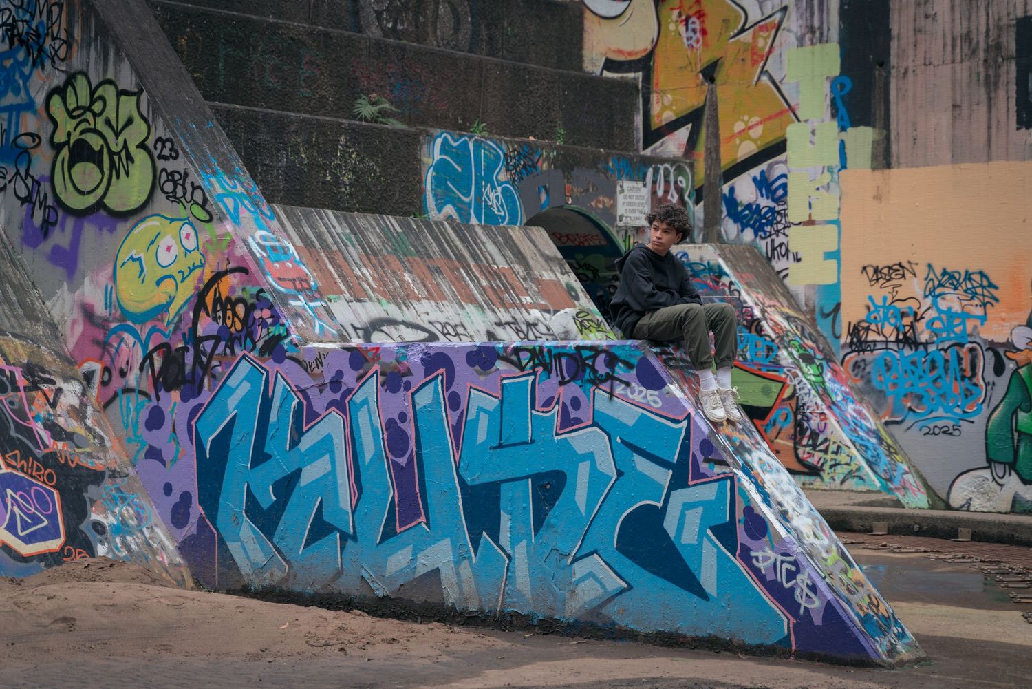 Colorful graffiti art covering concrete stairs in an urban setting.