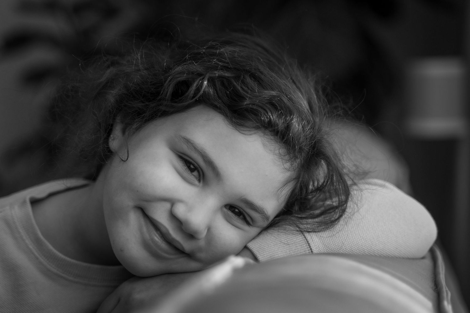 Black and white sequence of peaceful resting poses with gentle lighting.