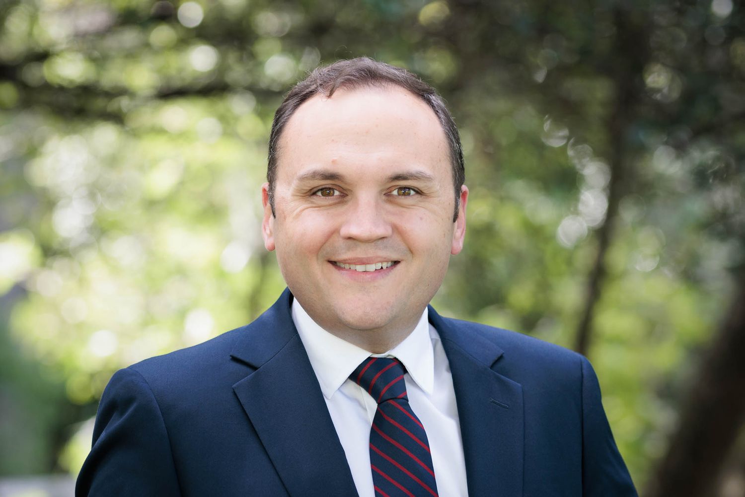 Professional headshot of Nick Leggett in a natural outdoor setting.