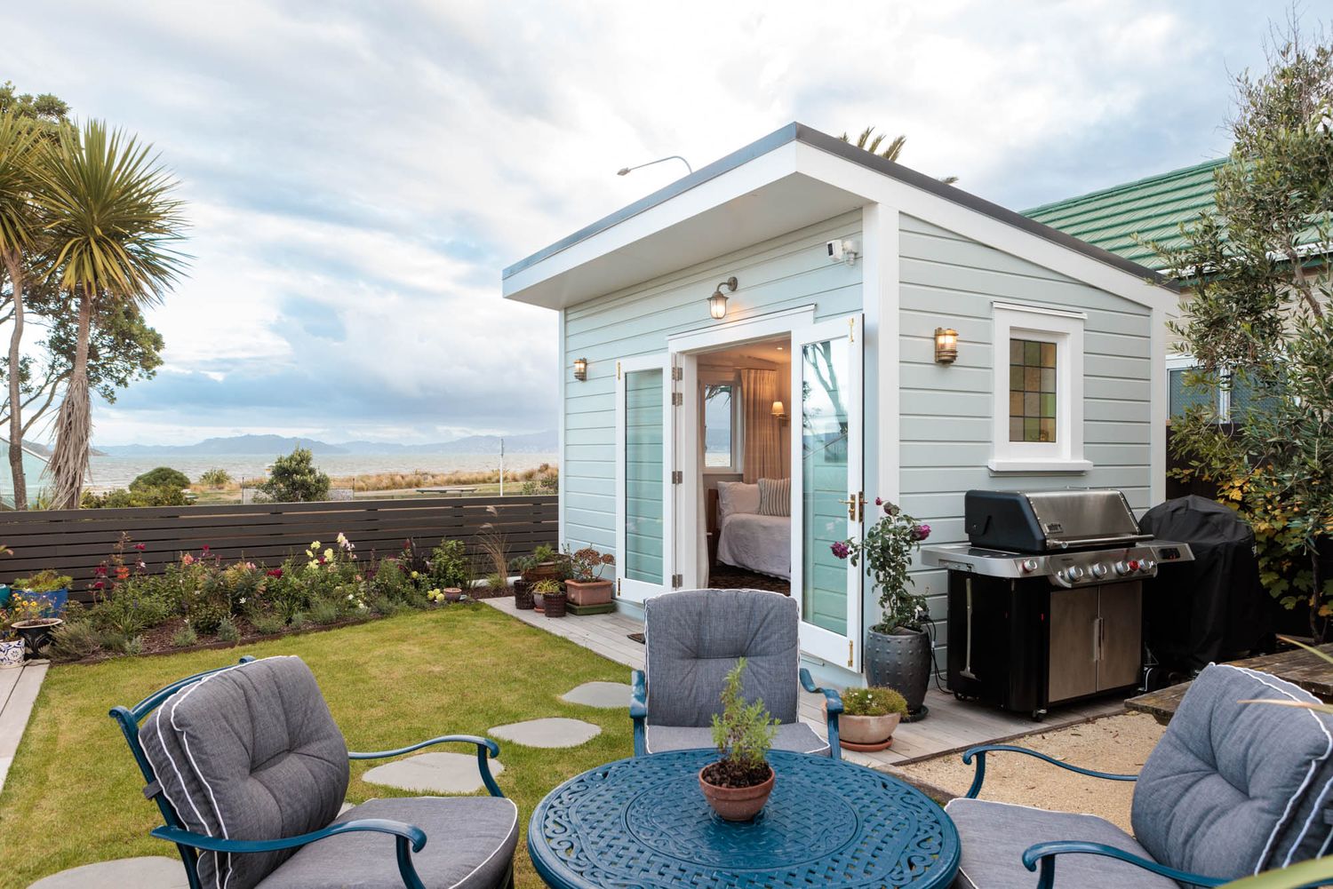 Luxury beachfront property with outdoor seating overlooking the ocean.