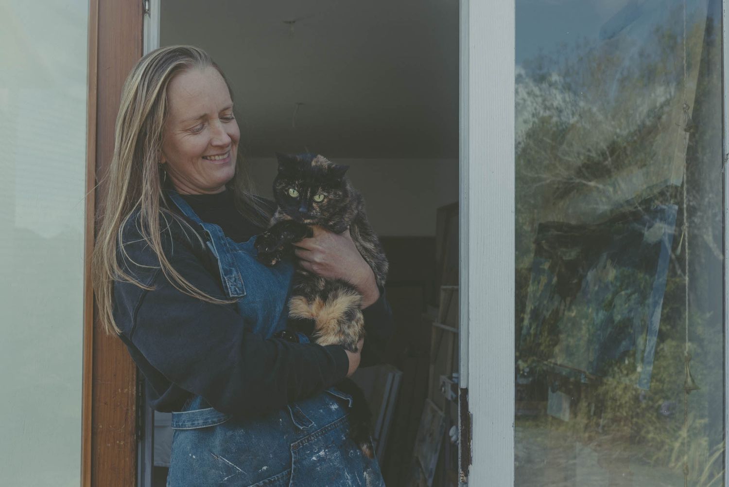 Veronica Young artist and her tortoiseshell cat.