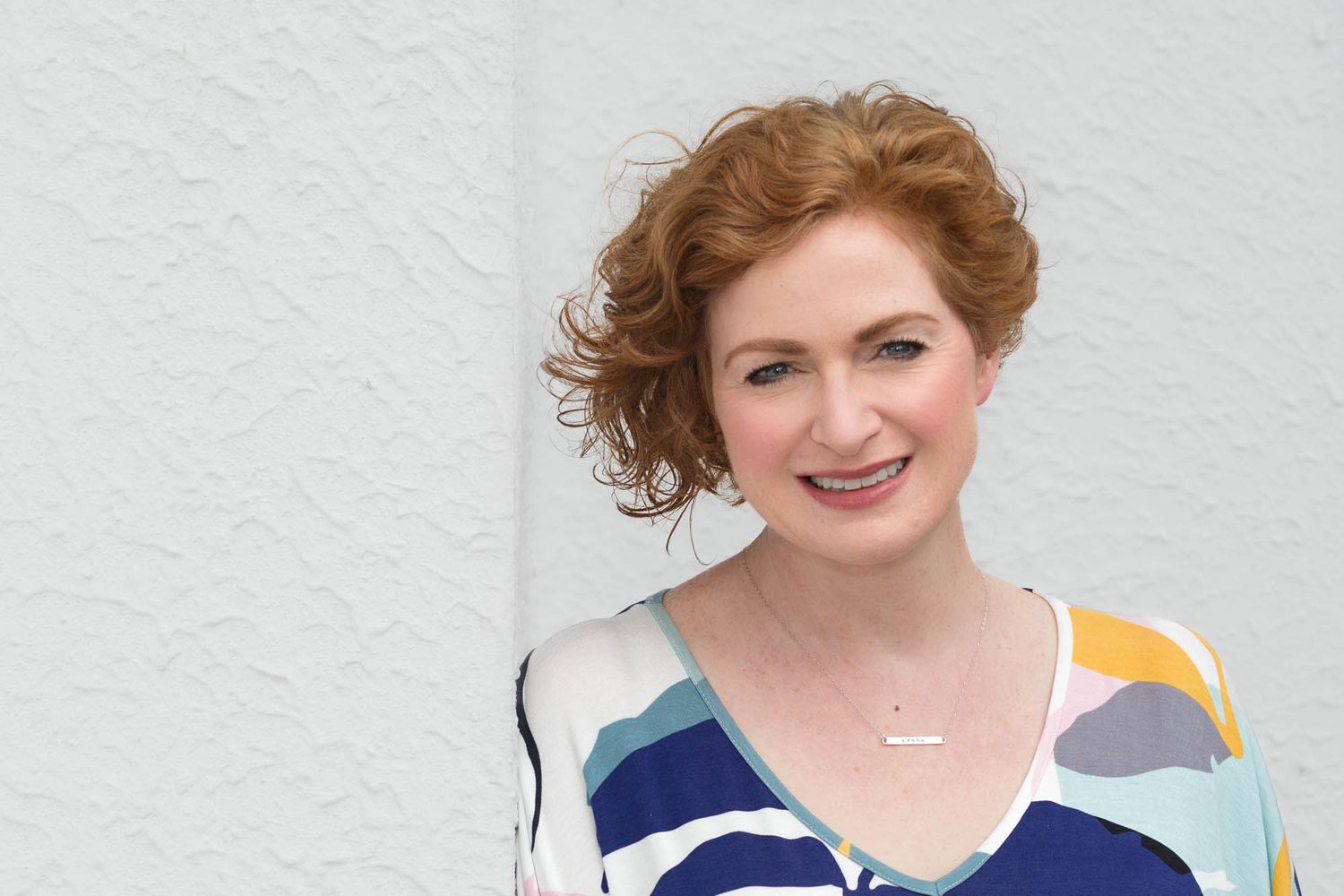 Professional headshot portrait of Susie Ferguson from Brazen wearing colorful business attire.