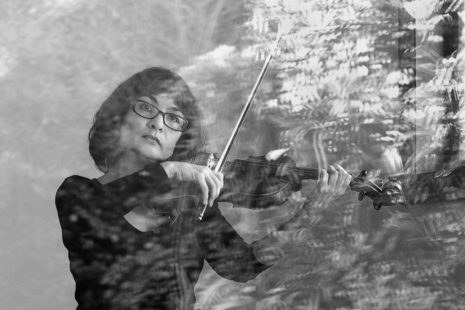Black and white artistic photograph showing violinist performing.
