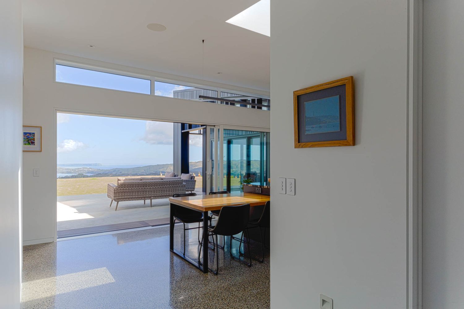 Bright interior space with white walls and skylight creating natural illumination.