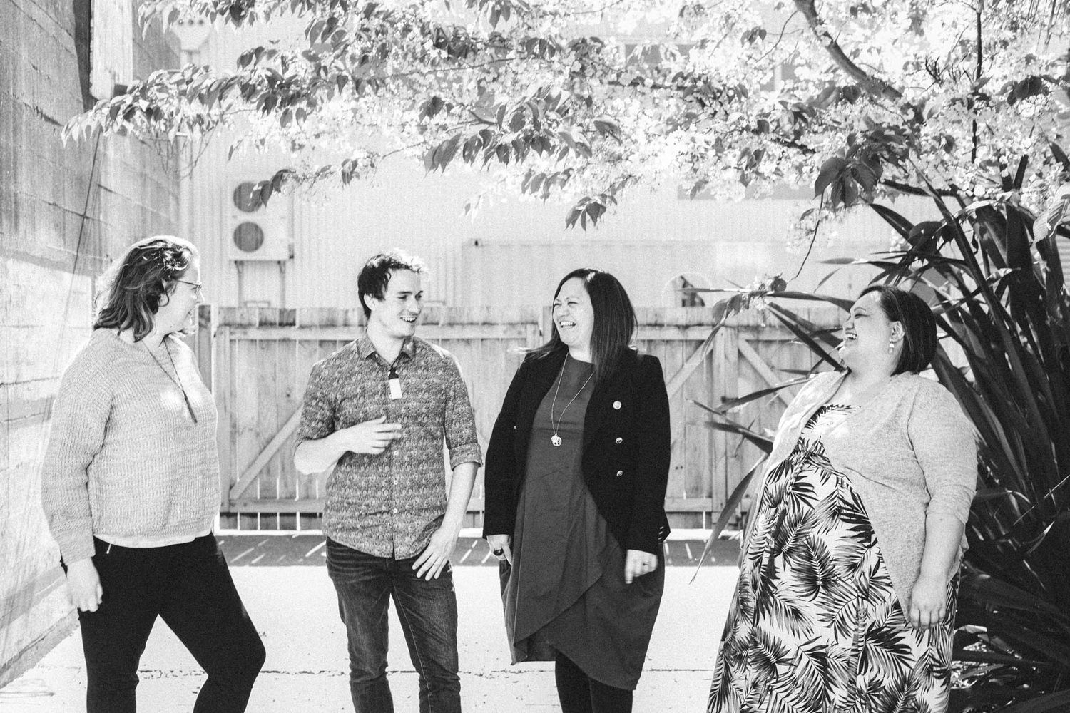 Black and white photo of people standing together in an outdoor setting.