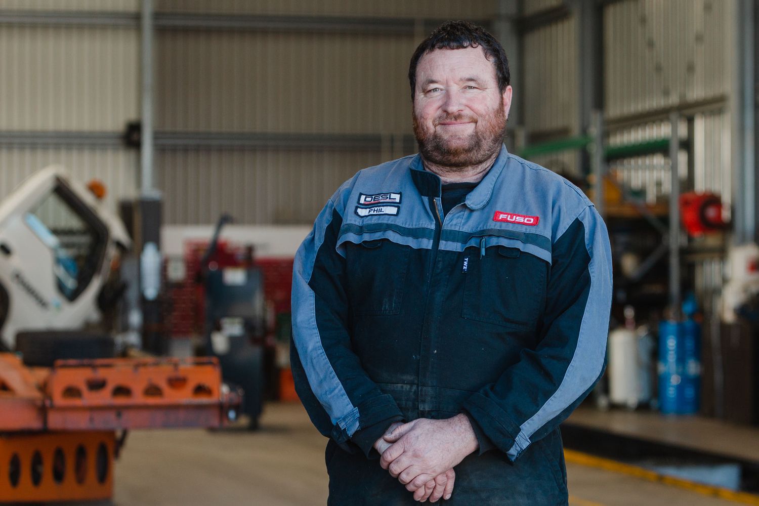 Professional mechanic working in an automotive repair shop with modern equipment and tools.