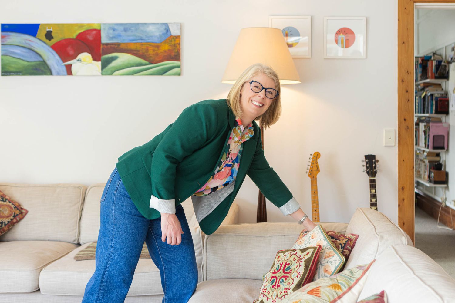 Interior designer arranging sofa cushions.