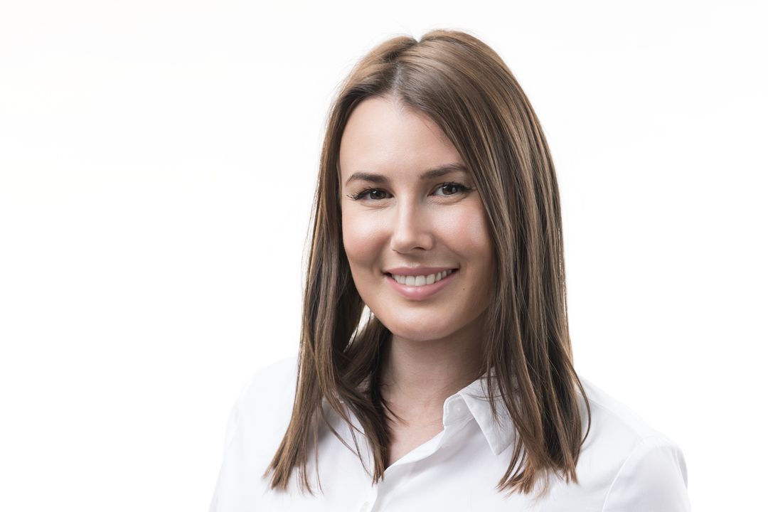 Professional headshot photos of three women with brown hair wearing white tops against light backgrounds.