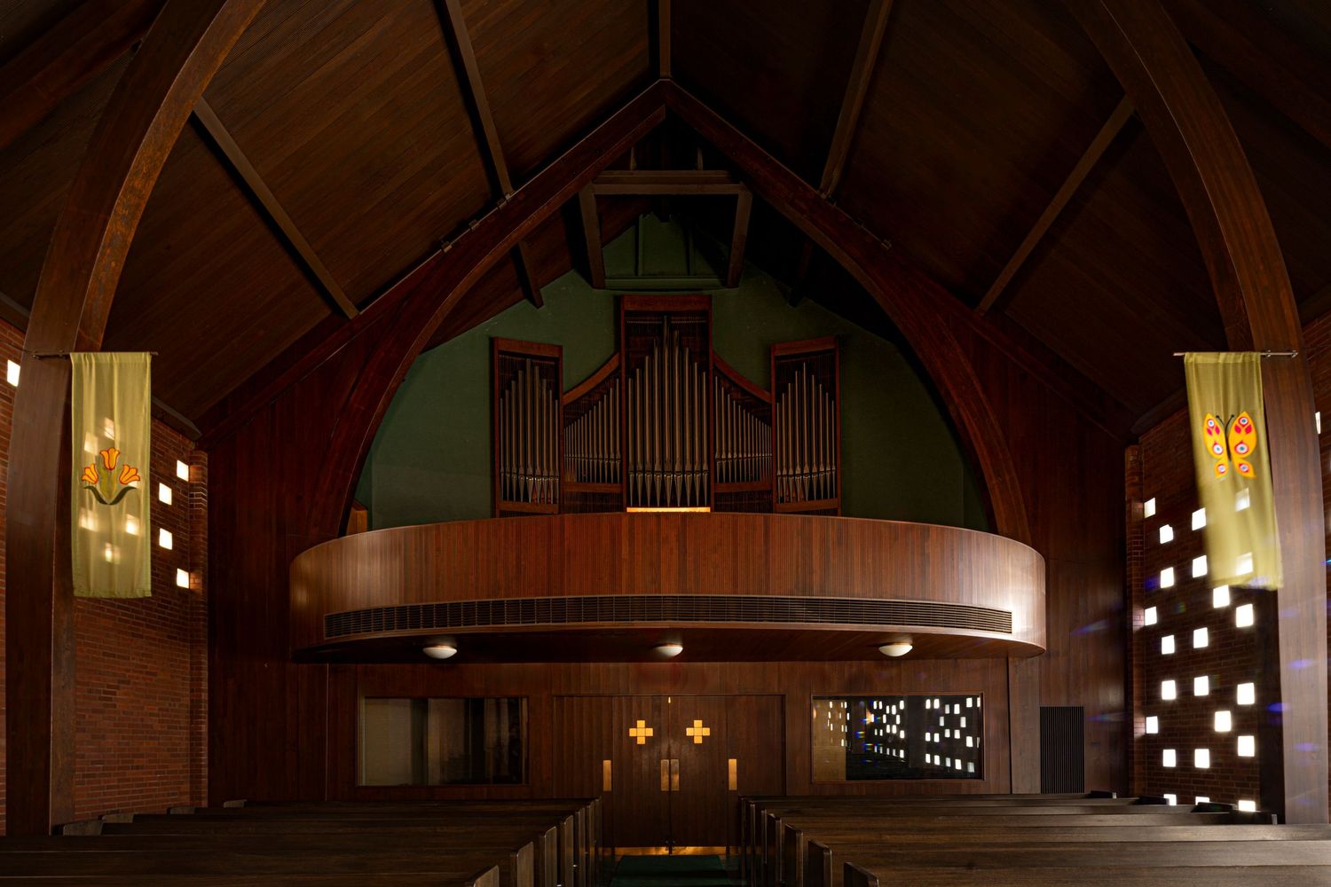 Pipe organ at back of church above wooden doors, Zion Lutheran Church