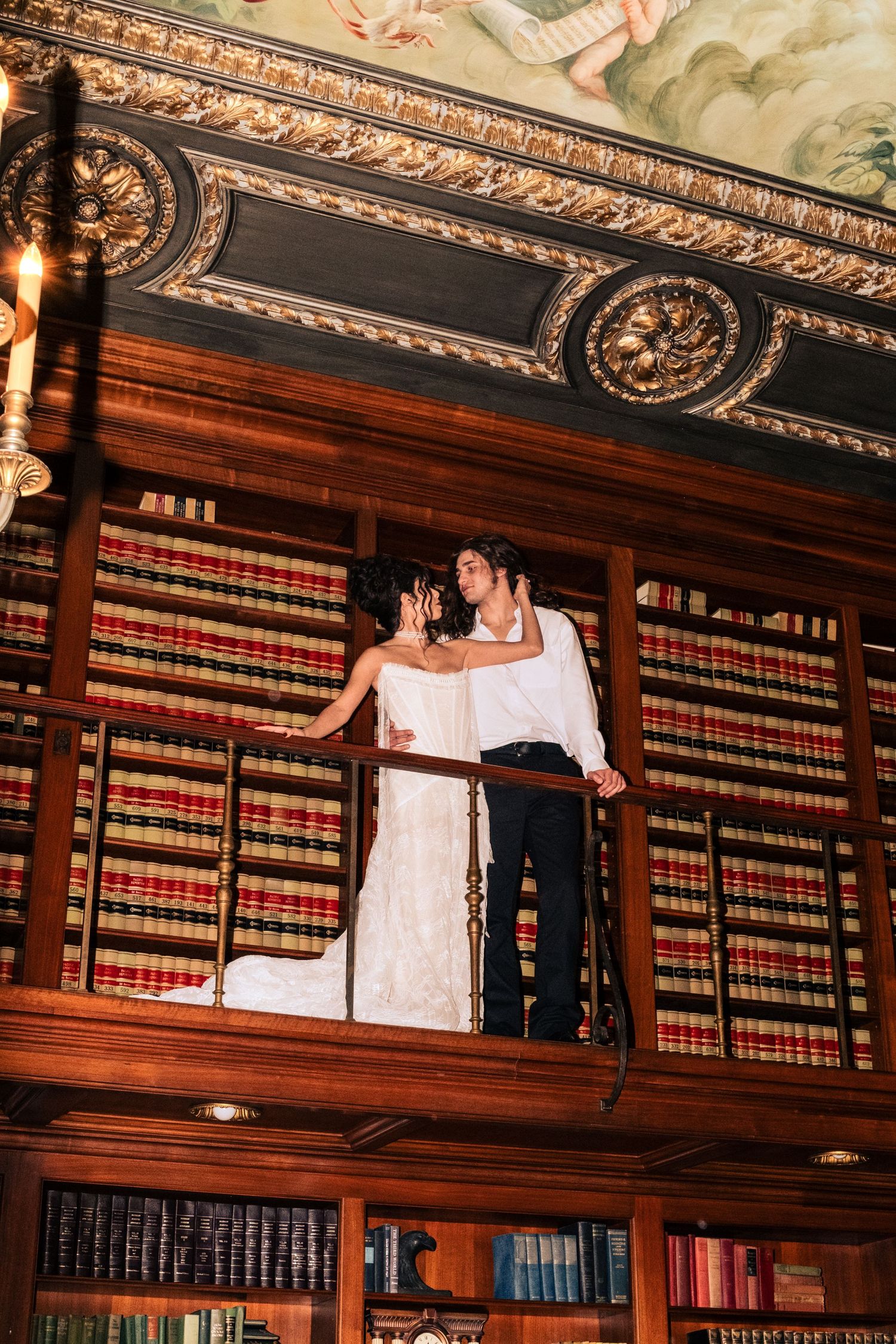 Ornate library interior with dark wood shelving, rows of law books, and decorative ceiling moldings in classical style.