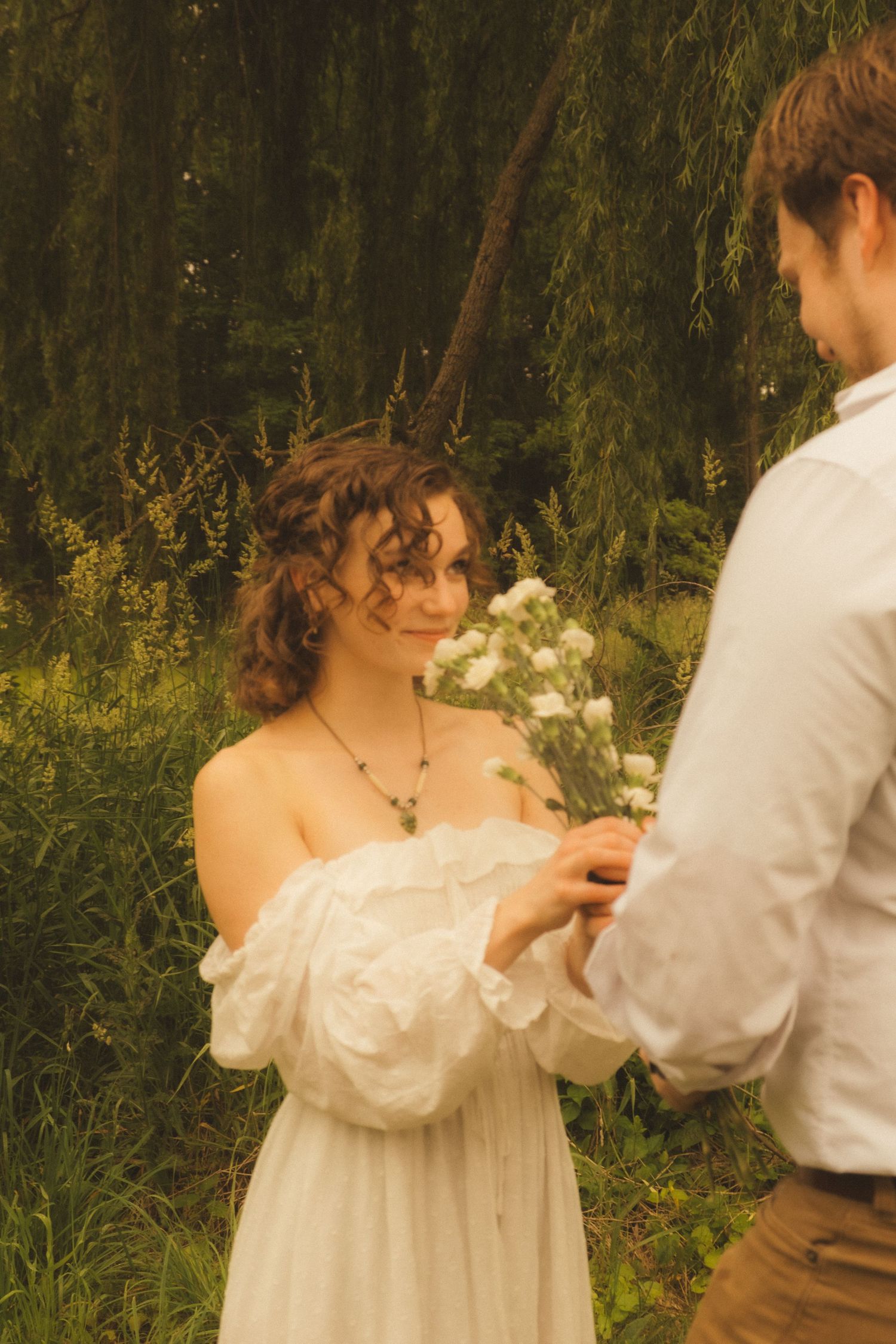 A romantic sequence of dance poses between a couple in vintage-inspired clothing set against a natural backdrop.