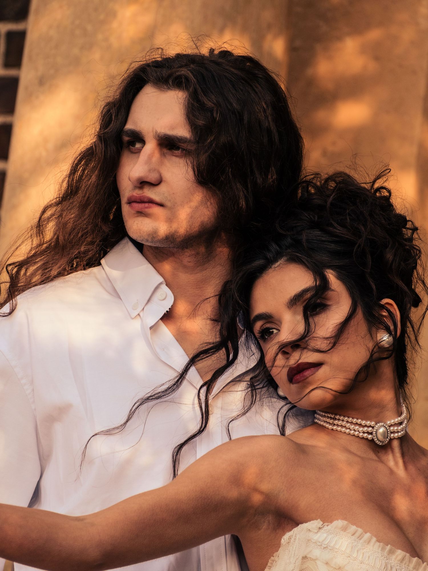 A romantic couple in warm sepia tones embracing intimately in a series of four connected photographs.