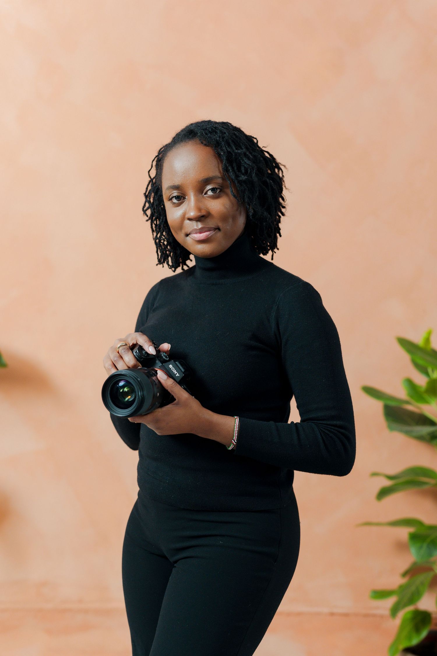A black woman holding a camera