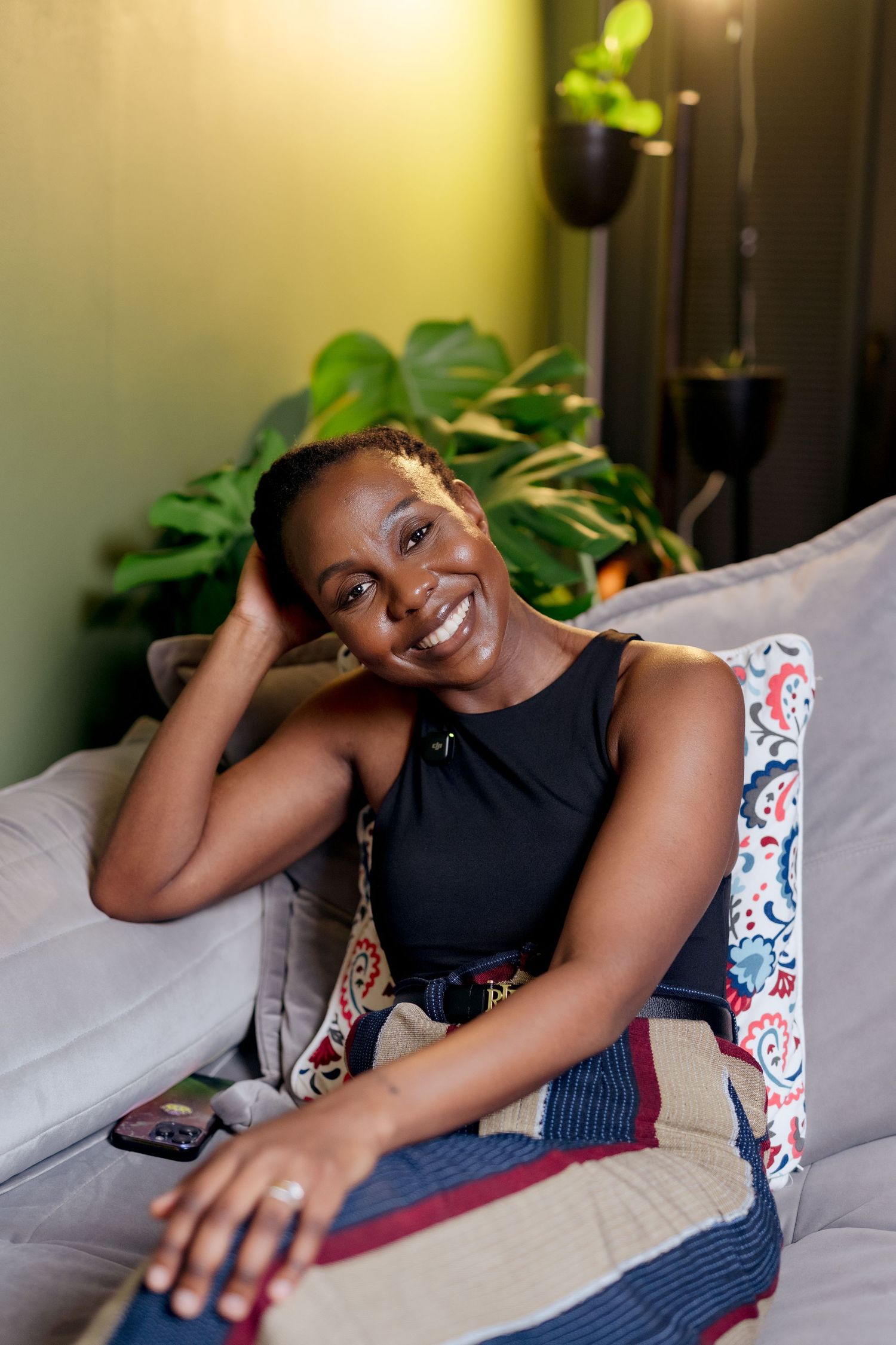 Portrait of a black woman leaning back on a couch