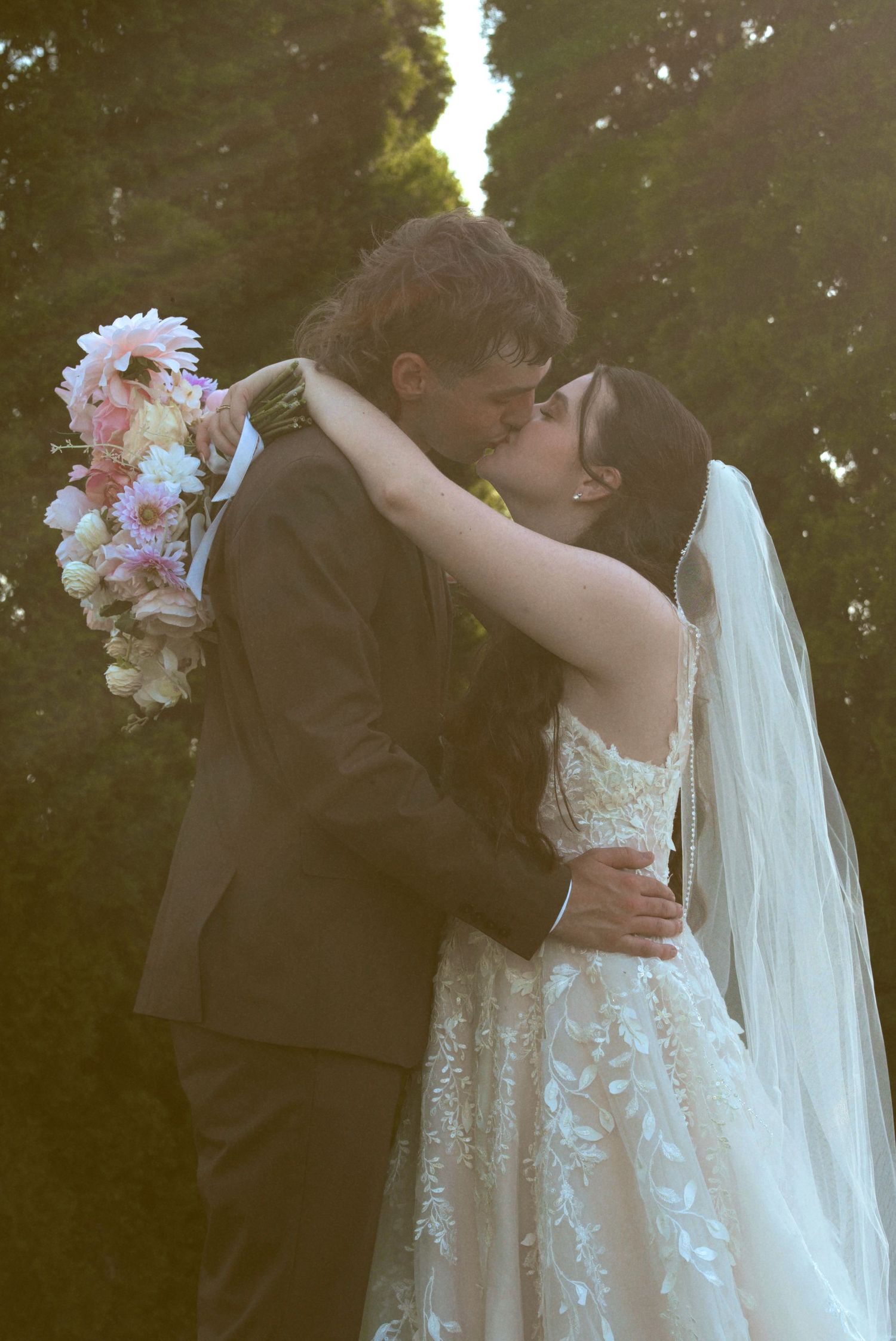 A romantic wedding moment captured in four sequential photos showing a tender embrace between newlyweds outdoors.
