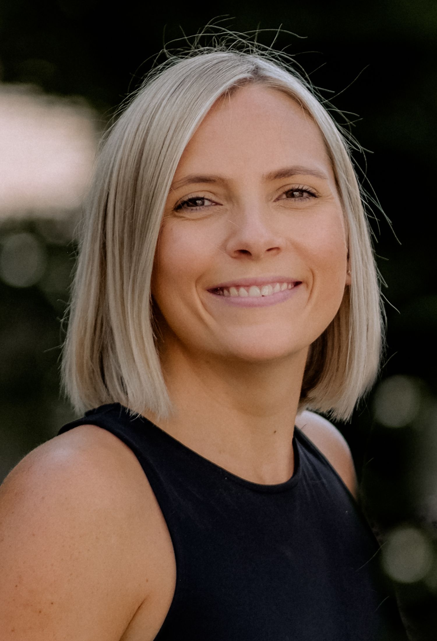 Blonde female who smiles at the camera and looks friendly and kind. Surrey Photographer