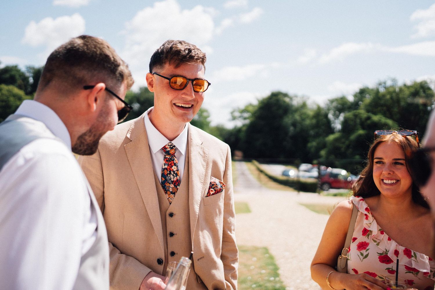 Wedding guests mingle and celebrate during an outdoor summer reception.