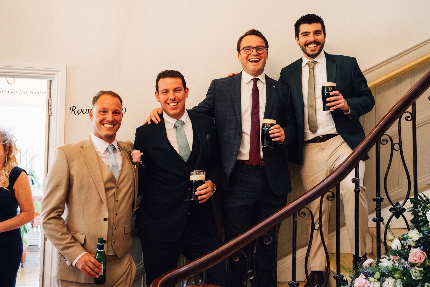 Wedding guests mingling and socializing on an elegant staircase during reception.
