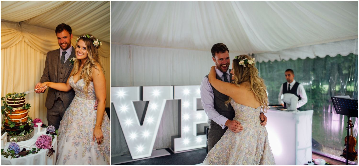 Wedding guests dancing and celebrating at an elegant reception under a white tent marquee.