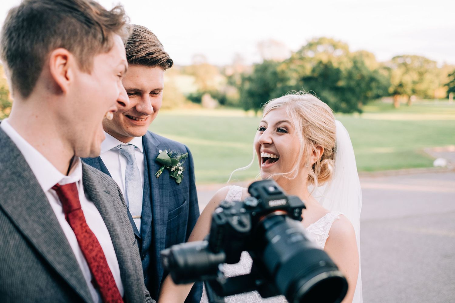 Joyful candid moments shared between wedding party members outdoors.