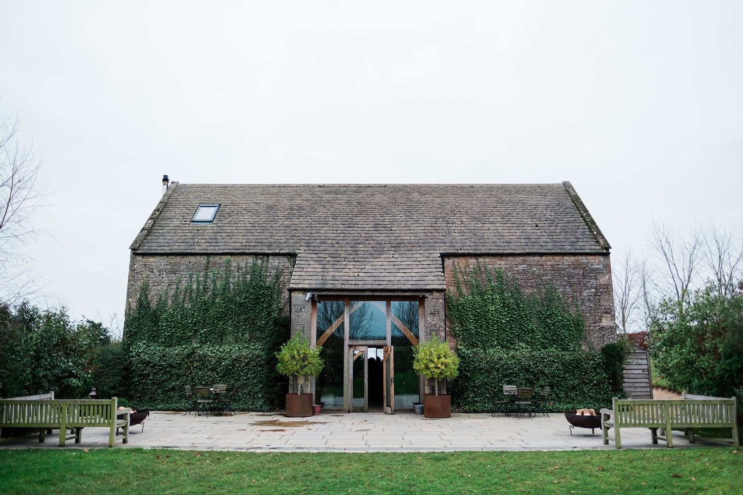 Panoramic view of a converted stone barn wedding venue in a rural setting.