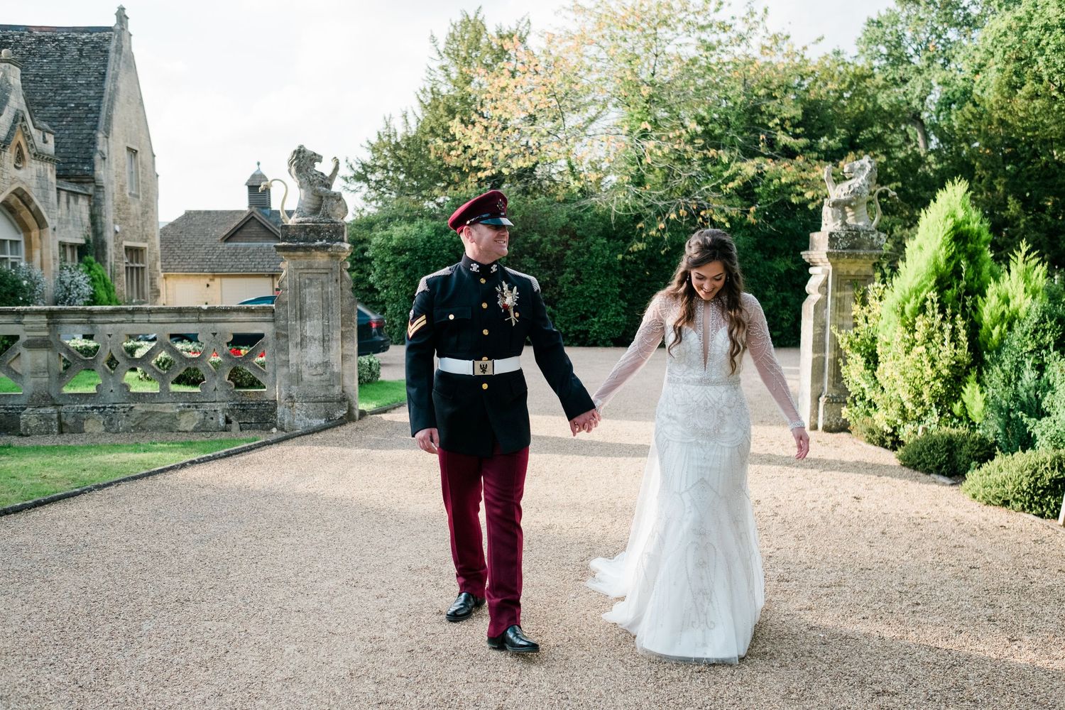 Wedding party walking along a stone path at a historic venue.