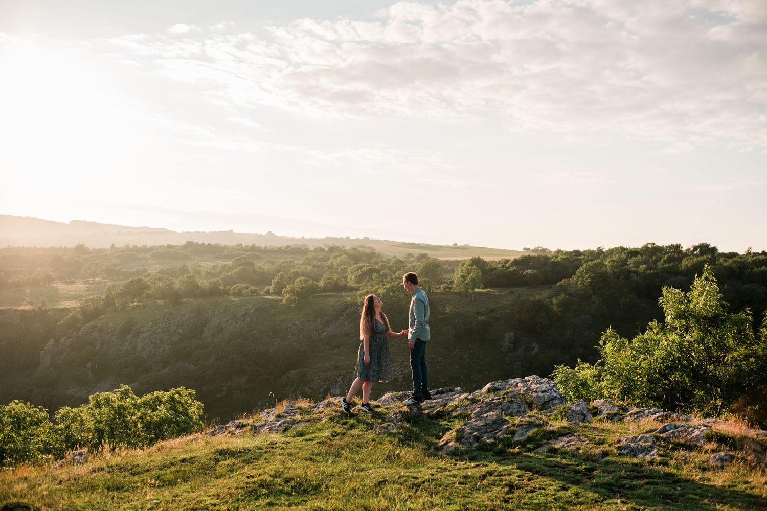 Beautiful panoramic view of countryside hills and valleys during golden hour.