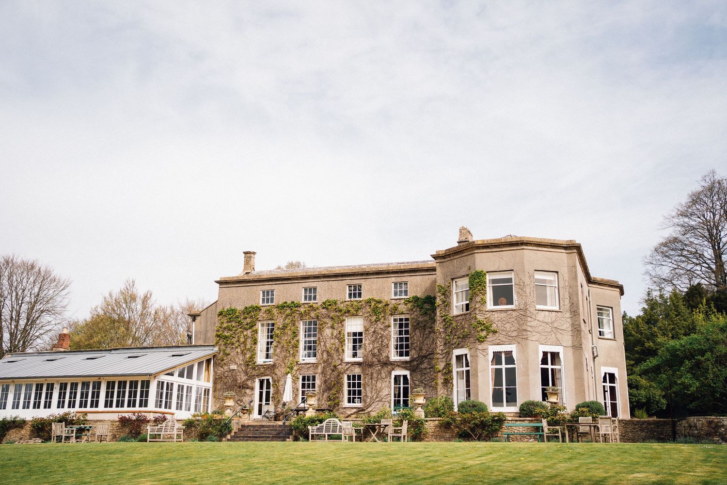 Elegant stone manor house with classic architecture serves as a wedding venue.