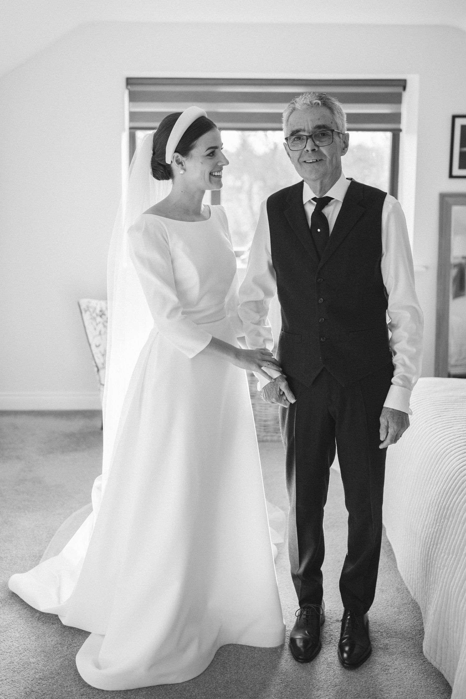 A series of black and white photos showing the bottom half of a wedding dress next to formal black pants.