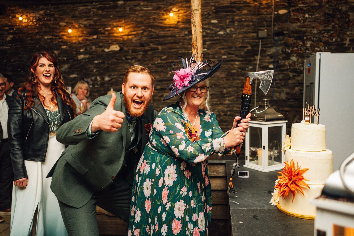 Wedding celebration at rustic stone wall venue with warm ambient lighting and festive atmosphere.