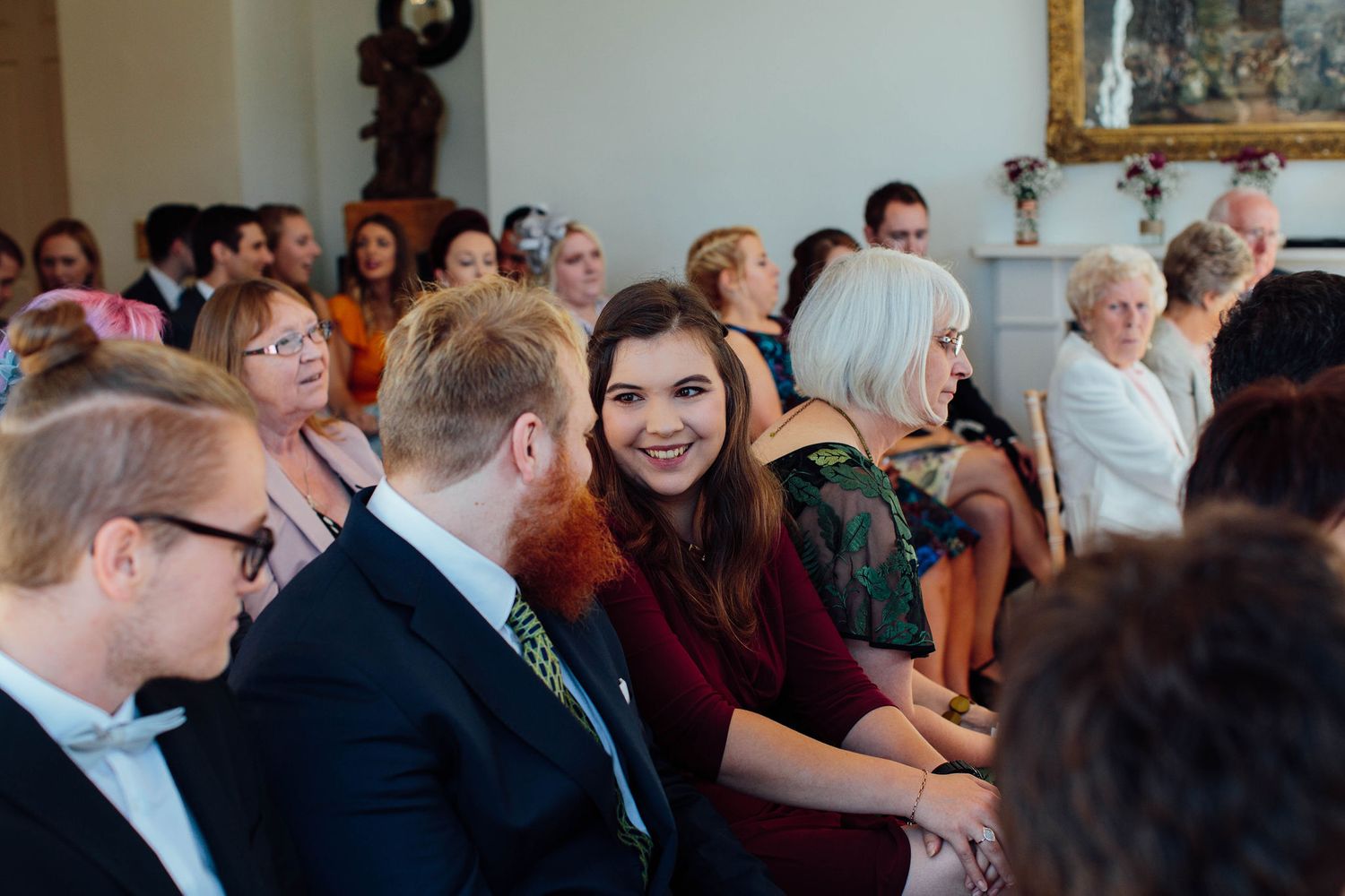 Wedding guests enjoying themselves during an indoor reception celebration.