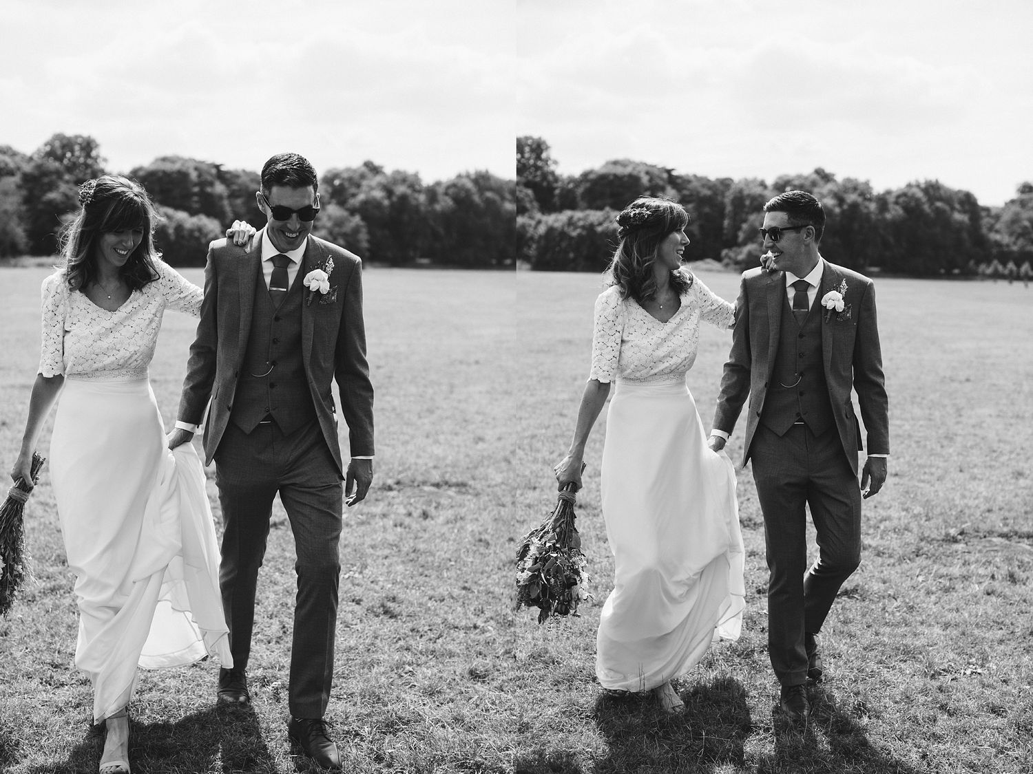 A black and white photo of couples walking through a countryside field in wedding attire.