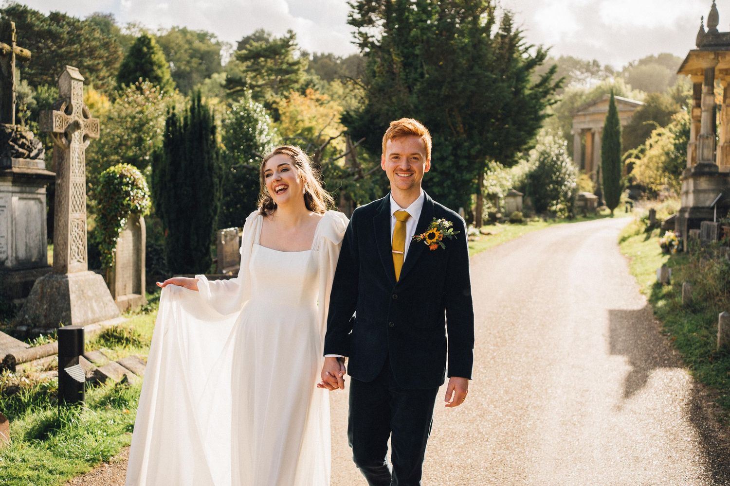 A couple walks along a scenic garden path during their wedding celebration.