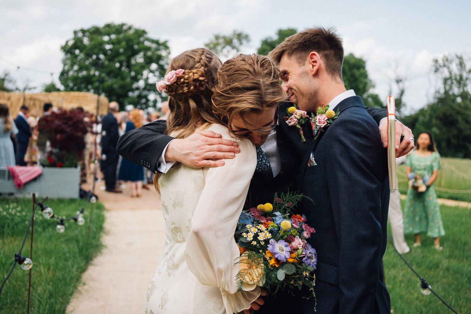An emotional moment captured during an outdoor wedding celebration.