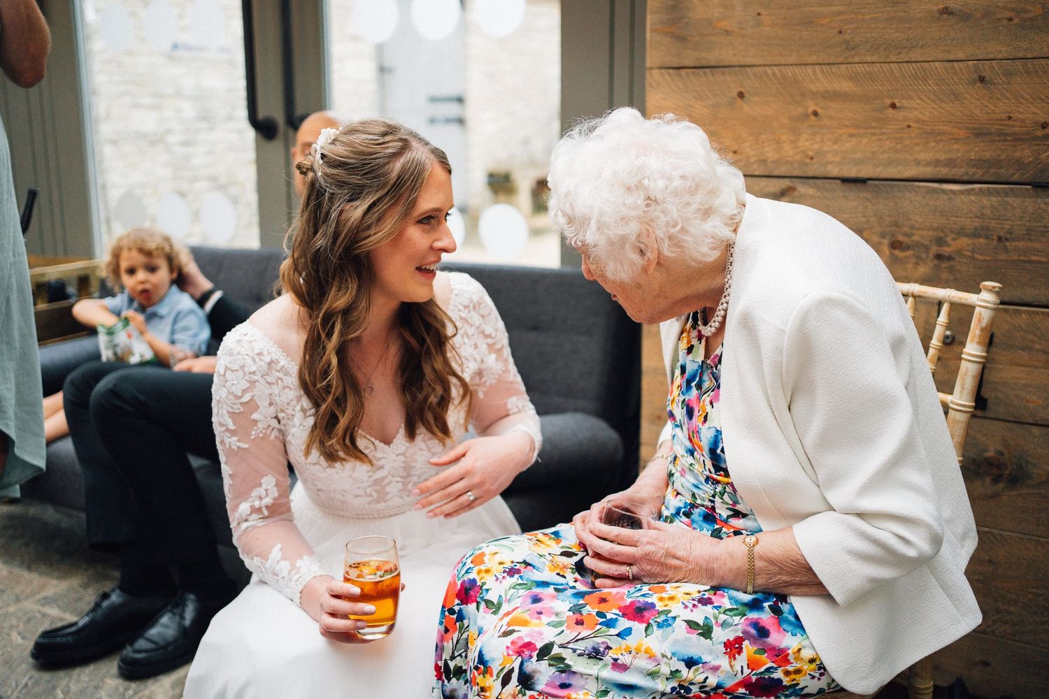Wedding party members relaxing and socializing in casual moments before the ceremony.