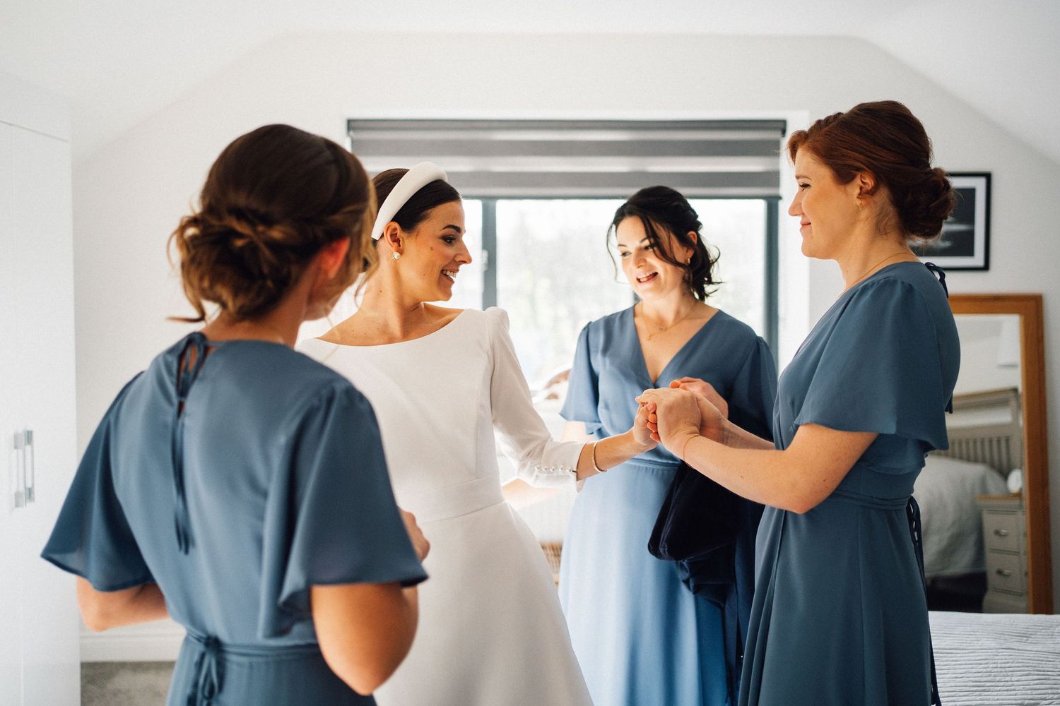 Healthcare professionals in blue scrubs and white coats collaborate in a medical office setting.