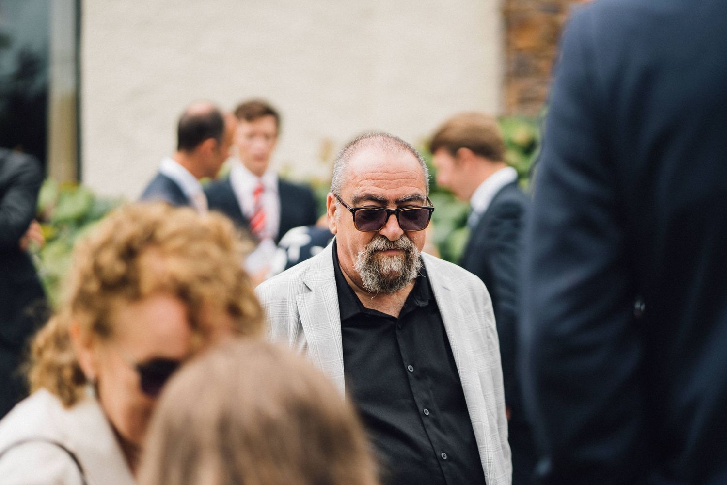 Wedding guests mingling during an outdoor cocktail reception.